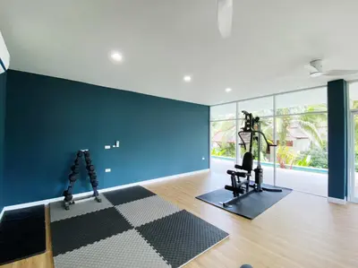 a room with a blue wall and a gym at L'esprit De Naiyang Beach Resort - SHA Extra Plus in Nai Yang Beach