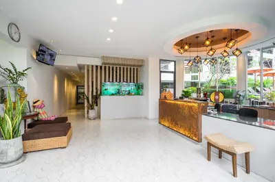 a living room with a fish tank on the wall at Baan Suwantawe in Phuket Town