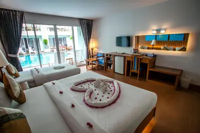 a room with two beds with a cake on it at Phi Phi Harbour View Hotel in Phi Phi Don