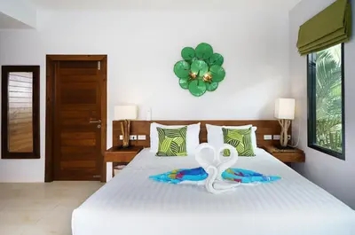 a bedroom with a bed with a ribbon on it at Nenuphar Villa by G Estate in Rawai Beach