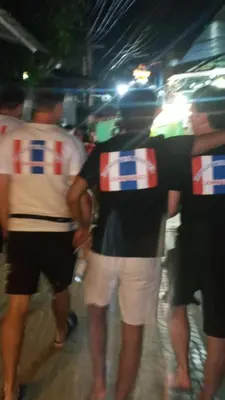 a group of men with british flags on their backs at Hangover Hostel in Phi Phi Don