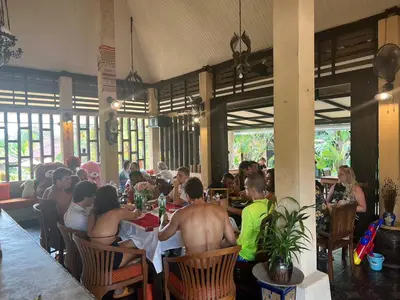 a group of people sitting at a table in a restaurant at Flora Ville-SHA PLUS in Chalong