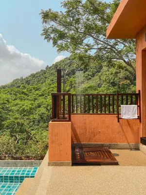 a balcony of a house with a view of a mountain at Korsiri Pool Villas in Panwa Beach