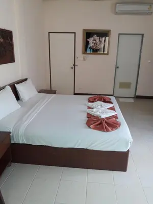 a bedroom with a bed with a robe on it at Southern Fried Rice in Kata Beach