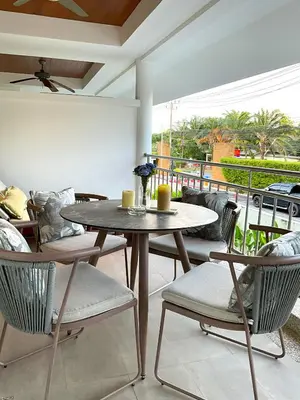 a dining room with a table and chairs on a patio at Bel Air Cape Panwa Resort Phuket in Panwa Beach