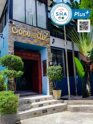 a building with a sign that reads coco villa at Cocoville Phuket - SHA Plus in Chalong