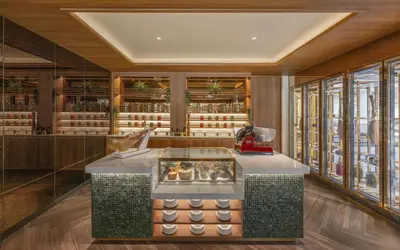 a bakery with a counter in a room with windows at Banyan Tree Phuket in Bang Tao Beach