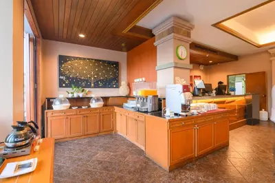 a large kitchen with wooden cabinets and a counter at Phuket Kata Resotel in Kata Beach