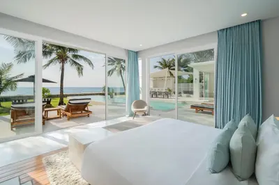 a bedroom with a bed and a view of the ocean at Coastal Escape Natai Beach in Natai Beach