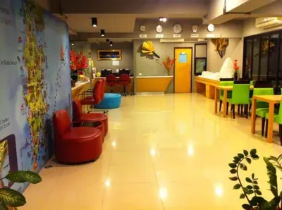 a waiting area of a restaurant with chairs and tables at The BluEco Hotel SHA Plus in Kata Beach