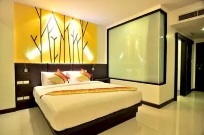 a bedroom with a large bed in a room at The BluEco Hotel SHA Plus in Kata Beach