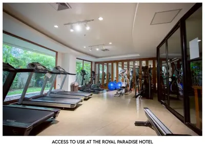 a gym with a row of treadmills and exercise equipment at The Corner in Patong Beach