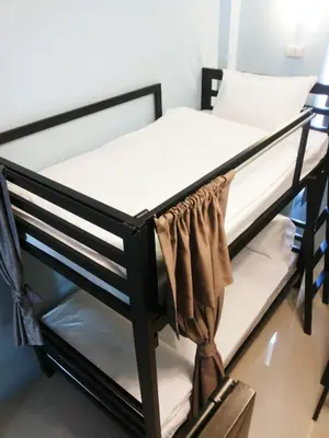 a black bunk bed in a room at One One Hostel Patong in Patong Beach