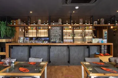 a restaurant with two tables and a bar at Diamond Resort Phuket Official Account in Bang Tao Beach