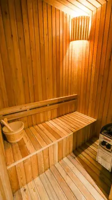 a wooden sauna with a bench in the middle at Diamond Resort Phuket Official Account in Bang Tao Beach