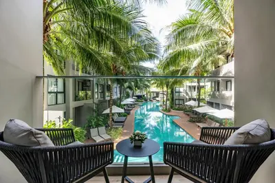 a view of the pool from the balcony of a resort at Diamond Resort Phuket Official Account in Bang Tao Beach