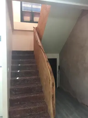 a staircase in a house with a wooden railing at Villa Kamala Beach in Kamala Beach