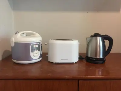 two toasters and a toaster and a kettle on a counter at Surin House in Surin Beach
