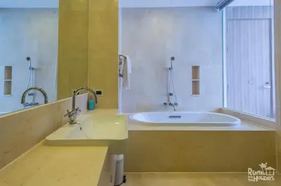 a large bathroom with a tub and a sink at Baan Mai Khao Condominium in Mai Khao Beach