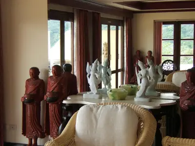 a group of people standing around a table in a room at Prince Edouard Apartments & Resort Patong Beach Phuket in Patong Beach