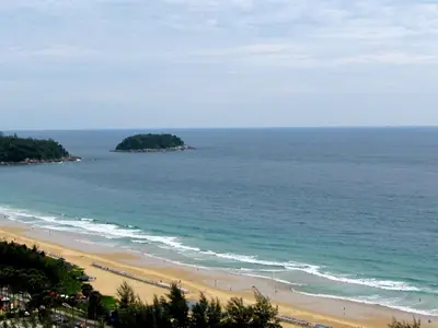 a view of a beach and the ocean at Waterfront Suites Phuket by Centara in Karon Beach