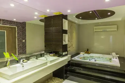 a bathroom with two sinks and a bath tub at The L Resort, Krabi in Ao Nang Beach