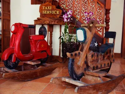 two wooden motor scooters are sitting in a room at The Orchid House - SHA Extra Plus in Kata Beach