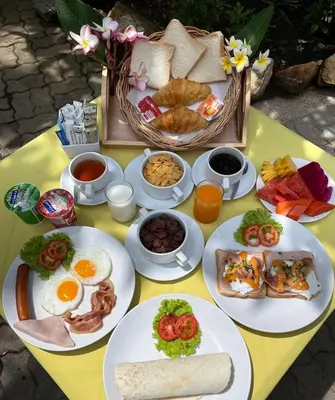 a table with plates of breakfast food on it at Phuket Golden Sand Inn - SHA Extra Plus in Karon Beach