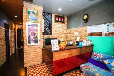 a bar in a restaurant with a counter and a couch at Sino House Patong in Patong Beach
