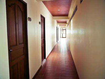 an empty hallway with a door and a tiled floor at Baan SS Karon in Karon Beach