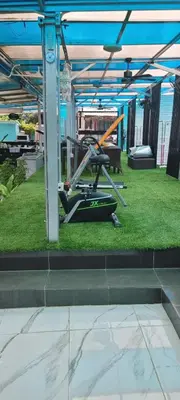 a exercise machine sitting on the grass under a roof at Blue Paradise Residence in Rawai Beach