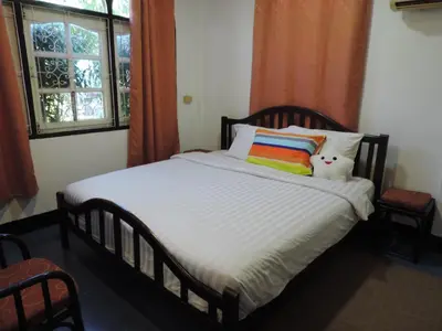 a bedroom with a bed with a teddy bear on it at Blue Paradise Residence in Rawai Beach
