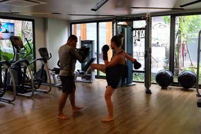 a man and a woman exercising in a gym at The Nature Phuket in Patong Beach