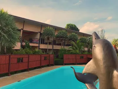 a statue of a dolphin next to a swimming pool at Maleedee Bay Resort in Ao Nang Beach