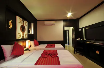 a hotel room with two beds and a television at Maleedee Bay Resort in Ao Nang Beach
