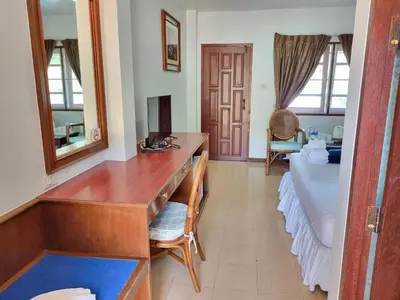 a bedroom with a desk and a bed in a room at Kata Interhouse Resort by Haii Collection in Kata Beach
