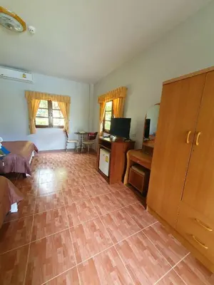 a living room with a wooden floor and a desk at Groovy Bungalows in Ao Nang Beach