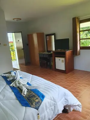a bedroom with a bed and a television in it at Groovy Bungalows in Ao Nang Beach