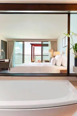 a bedroom with a large bed with a large window at The Westin Siray Bay Resort & Spa, Phuket in Phuket Town