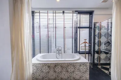 a bathroom with a bath tub with a sink at See Sea Villa Phuket SHA in Patong Beach