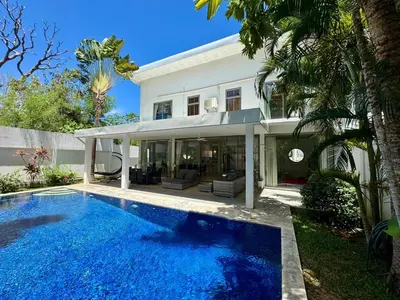 a swimming pool in front of a house at Miguel Villa by G Estate in Nai Harn Beach