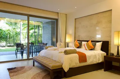 a large bedroom with a large bed and a patio at Nai Thon Beachfront Apartments in Nai Thon Beach