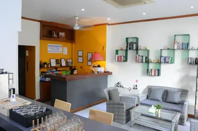 a living room with a bar and a table and chairs at Casa Jip Guesthouse in Patong Beach