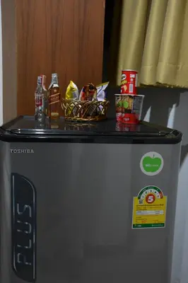 a close up of a washing machine with drinks on top at Casa Jip Guesthouse in Patong Beach