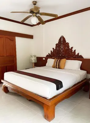 a bedroom with a large bed with a ceiling fan at Patong Palace Hotel - SHA Extra Plus in Patong Beach