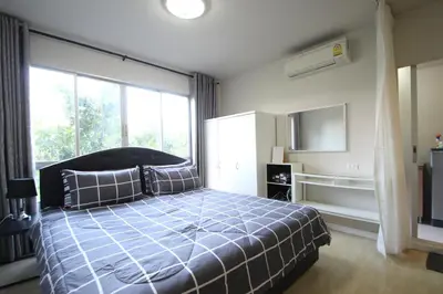 a bedroom with a bed and a large window at Dcondo Kathu Patong Phuket by Suna in Kathu