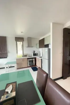 a kitchen with a table and a counter top at Kamala Villa Hill in Kamala Beach