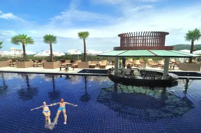 two people in the swimming pool at a resort at Princess Seaview Resort & Spa - SHA Plus in Karon Beach