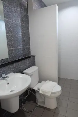 a bathroom with a white toilet and a sink at DOS'S HOUSE in Nai Yang Beach