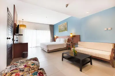 a living room with a bed and a couch at Deevana Plaza Krabi Aonang in Ao Nang Beach